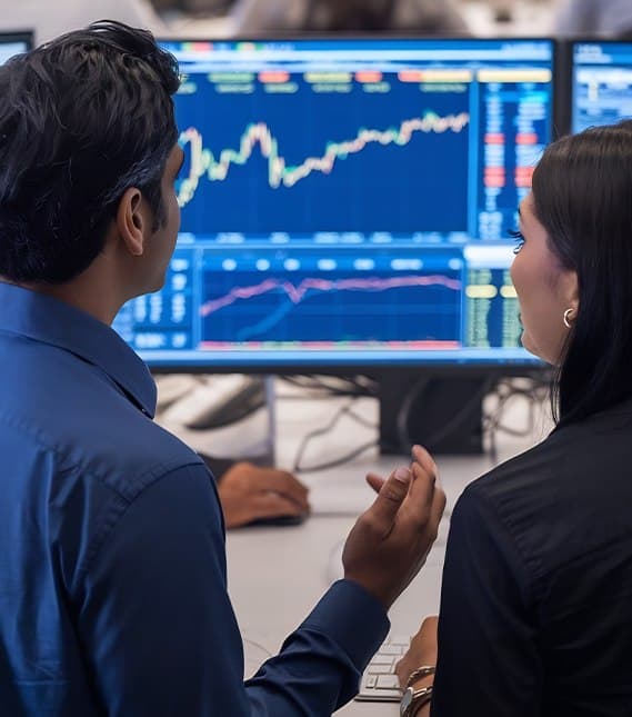 Traders reviewing live charts on a monitor